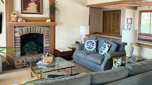 A living room with a fireplace, a sofa set, a coffee table, and a mirror. - BEST VALUE ON THE BEACH IN SEA PINES!
ALMOST OCEANFRONT! (Hilton Head Island)