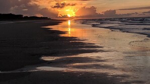 A beach at sunset with the sun reflecting on the wet sand. - BEST VALUE ON THE BEACH IN SEA PINES!
ALMOST OCEANFRONT! (Hilton Head Island)