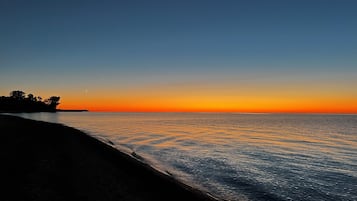 Enjoy a serene beach scene with gentle waves lapping at the shore.