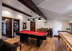 A pool table with a red felt surface, wooden flooring, and a ceiling with exposed beams. - Entire large home- Luxe, Walk to lift & town! Game room, hot tub (Park City)