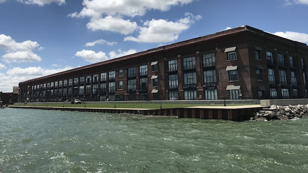A large, multi-story building with a flat roof, located adjacent to a body of water. - Spectacular Waterfront Condo Retreat For 6 w/ Cedar Point View! (Sandusky)