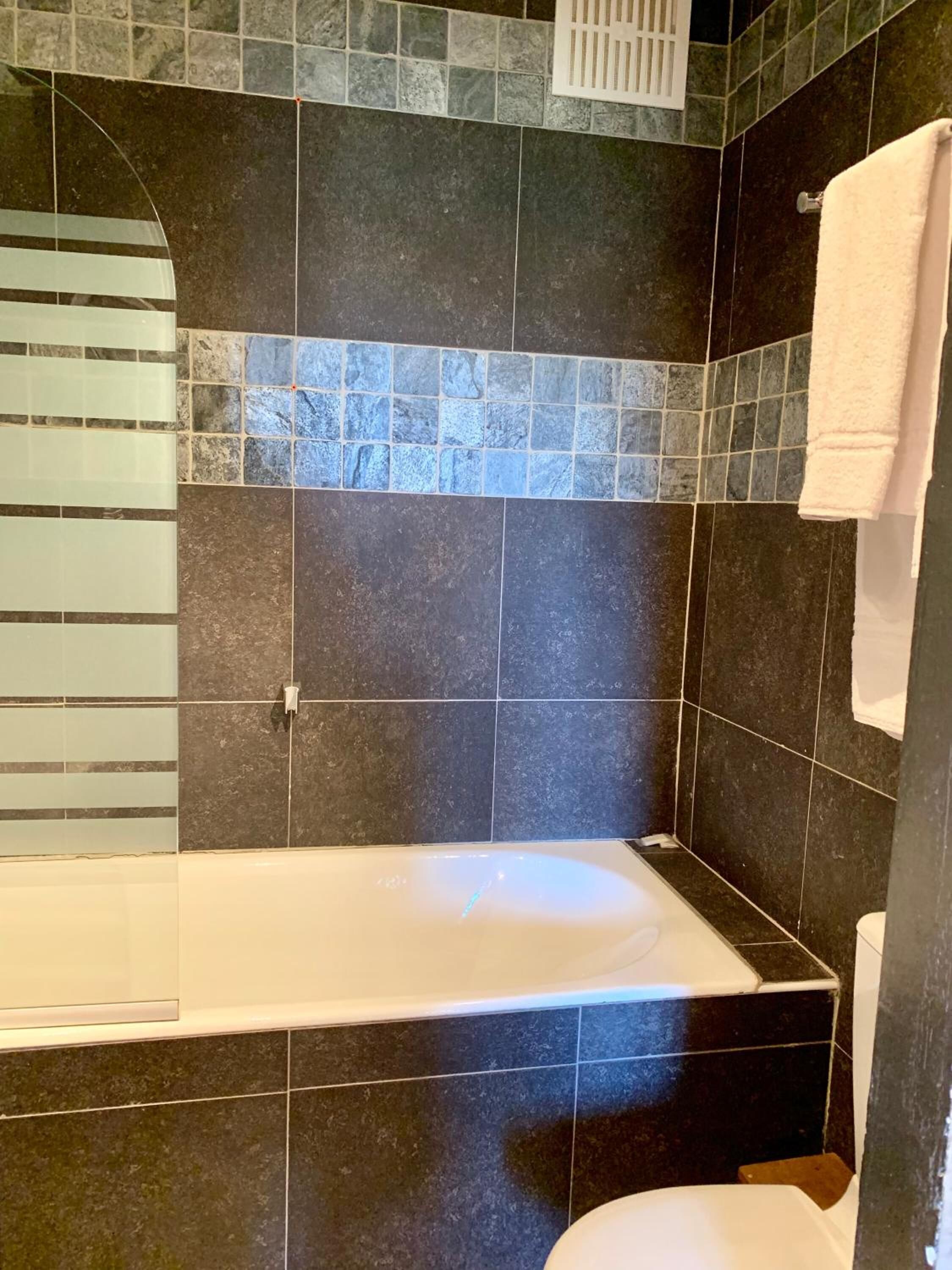 deep-soaking bathtub, hair dryer, towels