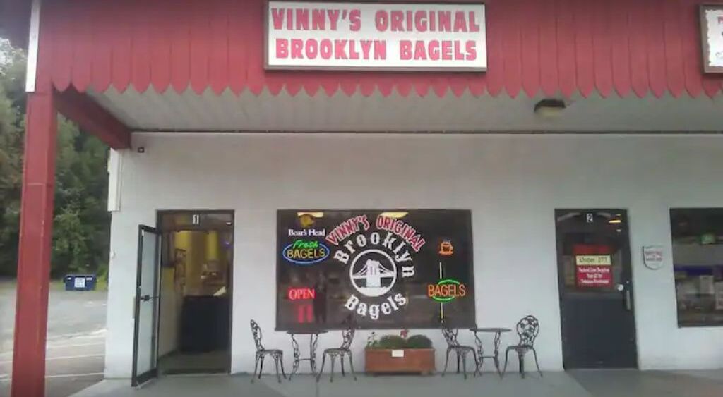 Vinny's Original Brooklyn Bagels storefront with a red awning and a signboard.