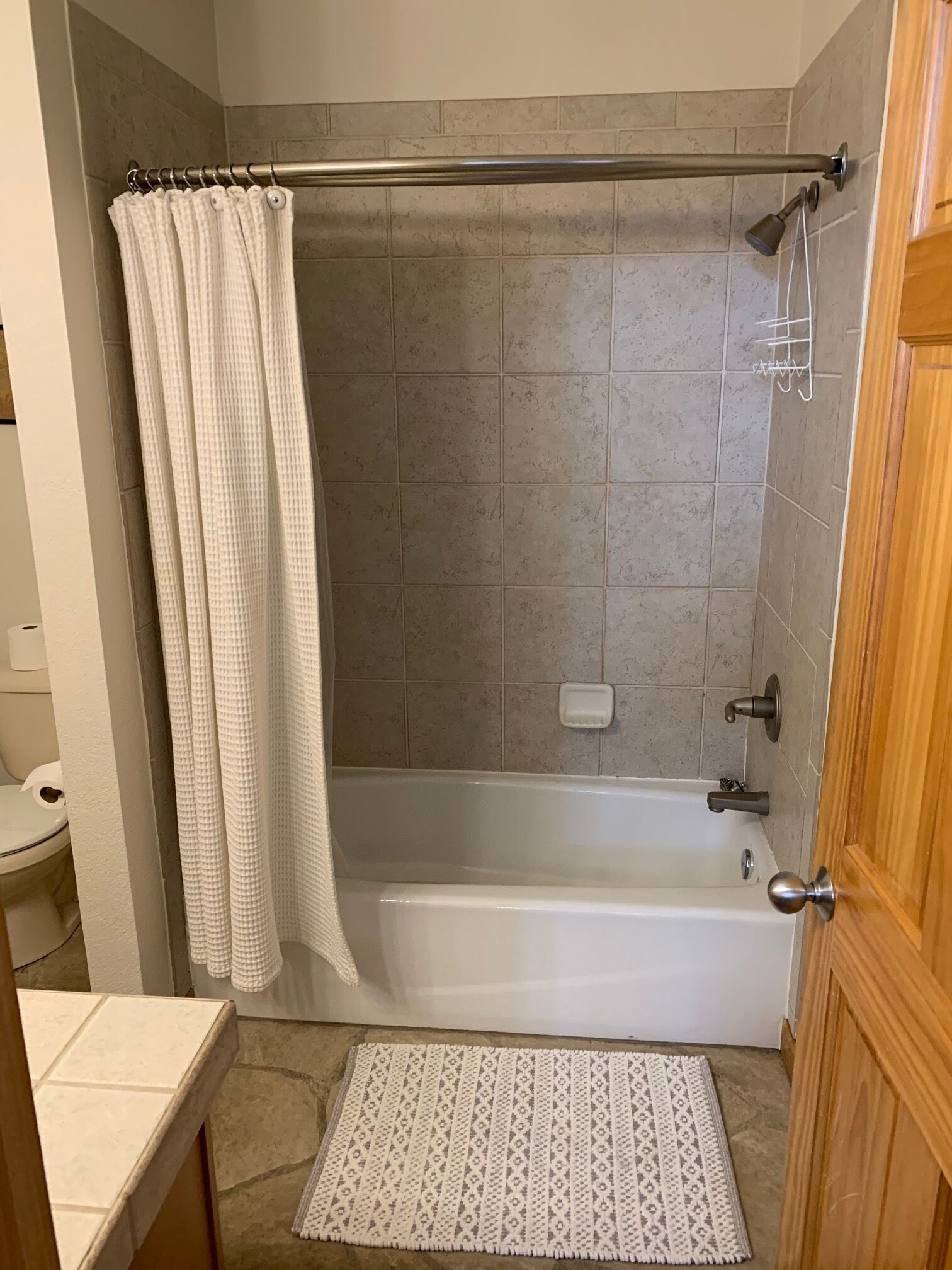 Een badkamer met een douche, toilet en wastafel.