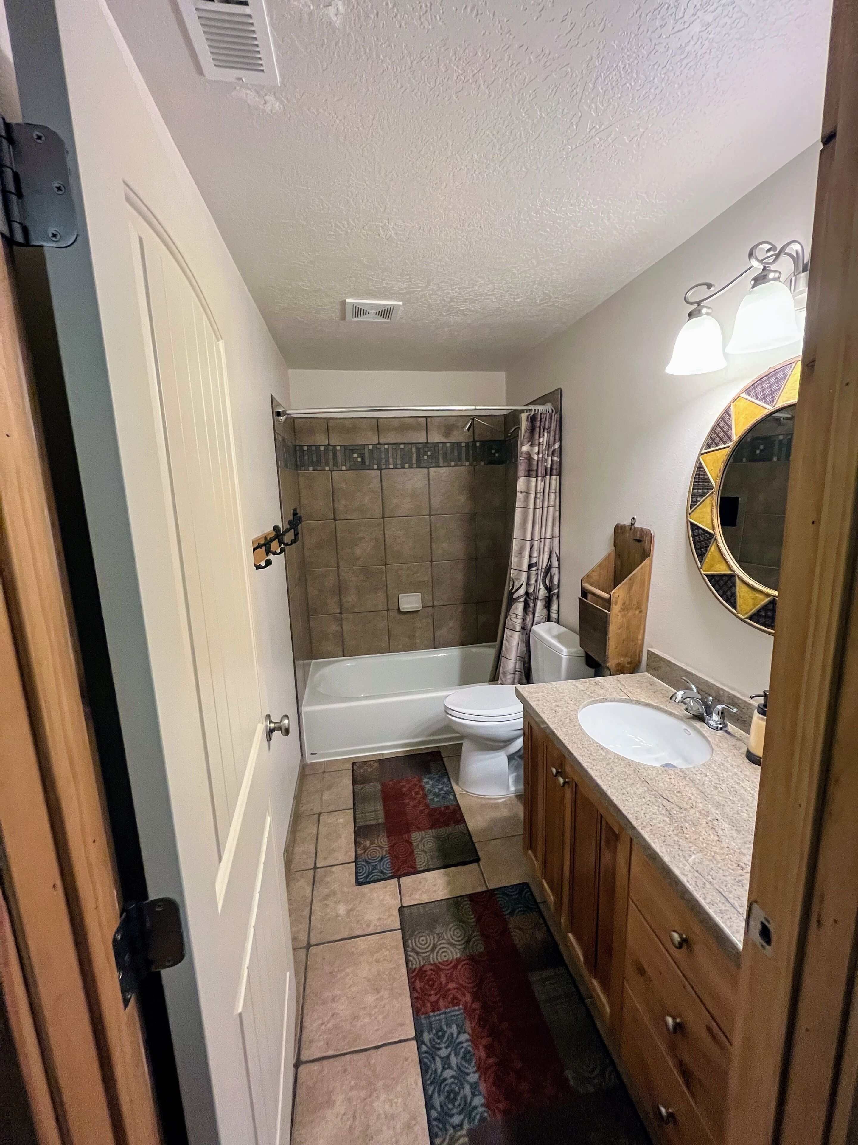 A bathroom with a bathtub, toilet, and sink.