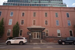 A red brick building with a central entrance and a glass facade above. - In The Heart of Lower Downton Denver in a beautiful historic building. Unit 303B (Denver)