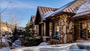 A stone building with a hot tub in front. - Large, Luxe, walk2town, 2 min DV & PC bases. Theater, game room, steam room (Park City)