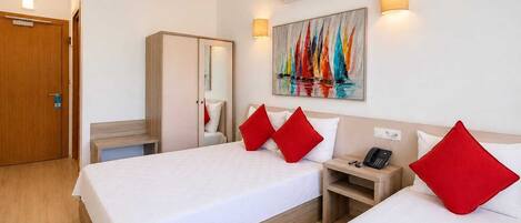 A hotel room with two beds, a wardrobe, a desk, an air conditioner, and a painting on the wall.