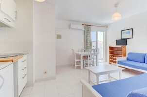 Apartment, 1 Bedroom, Balcony | Living area | Flat-screen TV