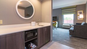 A modern bathroom with a sink, mirror, and cabinets. - Hampton Inn & Suites Allen Park (Allen Park)