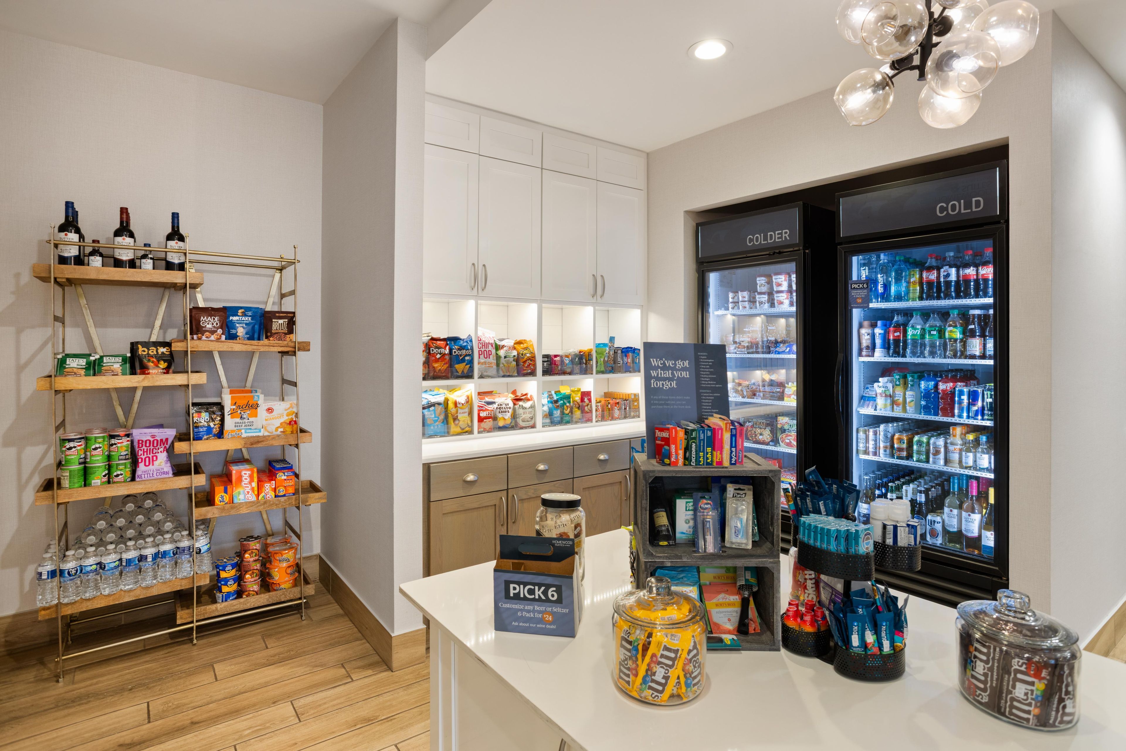 A self-service beverage station with a variety of drinks and snacks.