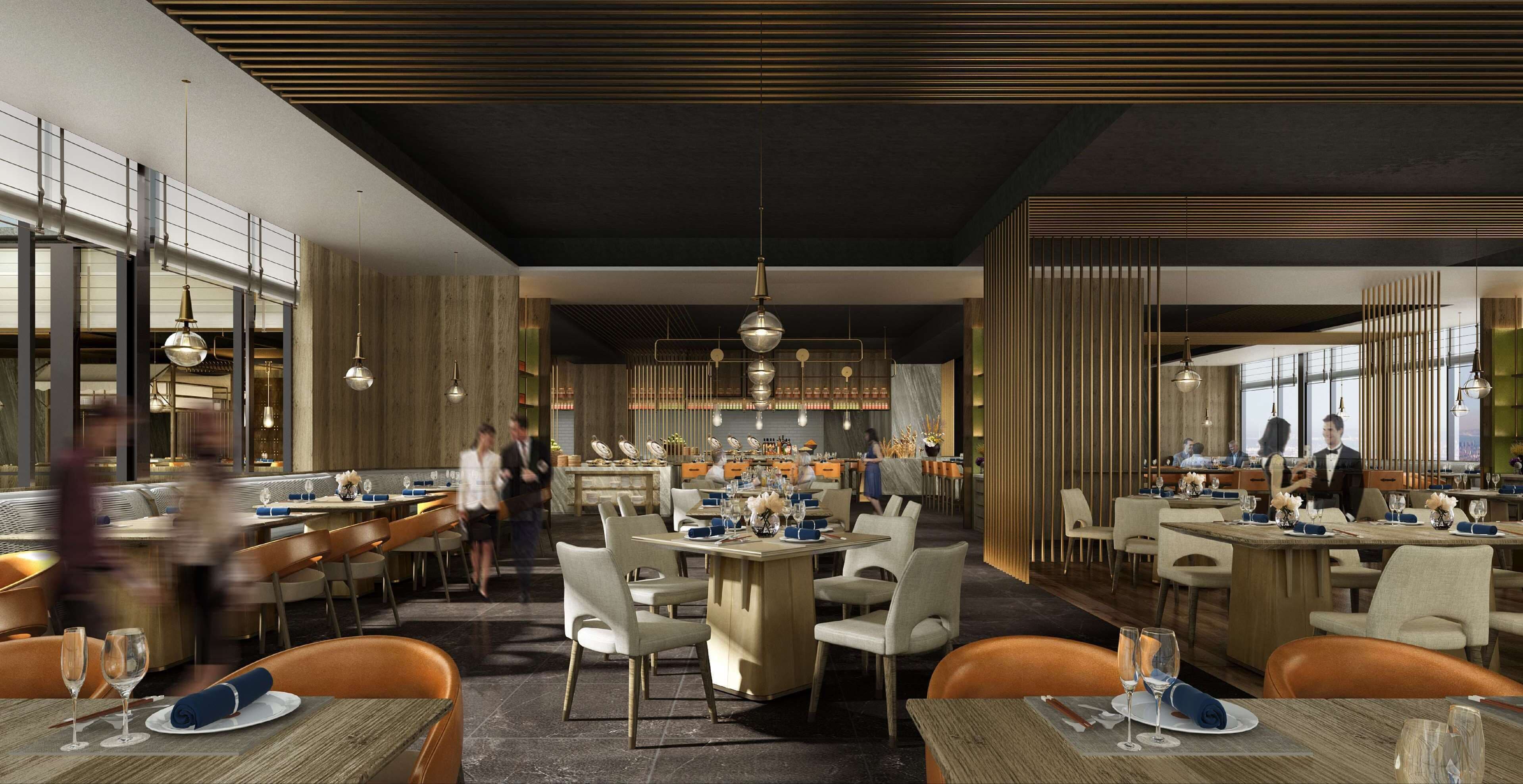 Un restaurant moderne avec plusieurs espaces de restauration, de hauts plafonds et des luminaires contemporains.