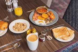 Enjoy a hearty breakfast with scrambled eggs, fresh croissants, and a variety of condiments.