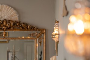 A wall-mounted light fixture with crystal details.