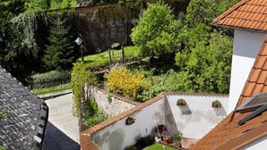 A residential area with a yellow house, a white building, and a stone wall. - Staroměstský penzion (Tabor)
