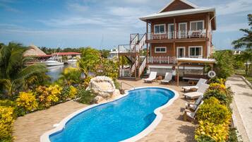 Relax by the resort's inviting pool surrounded by lush tropical landscaping and enjoy a scenic view from the balcony.