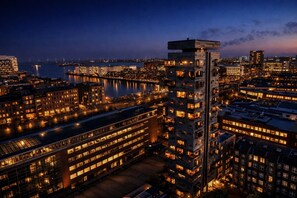 A high-rise building with multiple floors, large windows, and a flat roof. - Charlottehaven (Copenhagen)