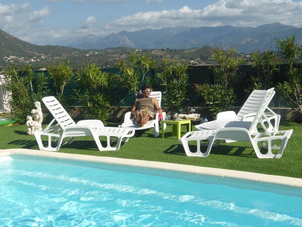 Seasonal outdoor pool, pool umbrellas, pool loungers