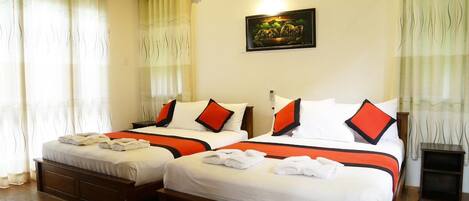 A hotel room with two beds, each with white bedding and red accents, a painting on the wall, and a tiled floor.