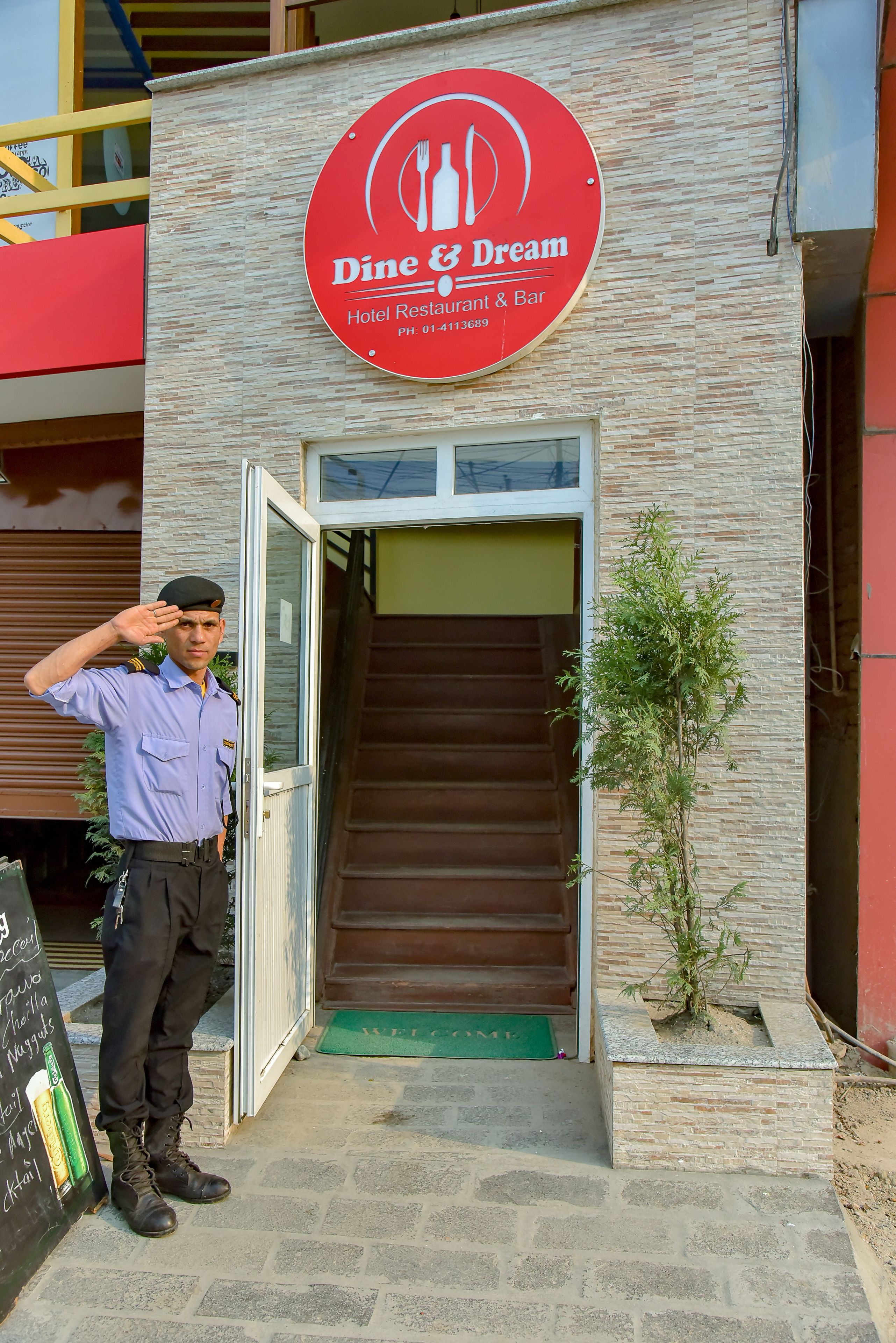 A hotel entrance with a sign for 'Dine & Dream Hotel Restaurant & Bar'.