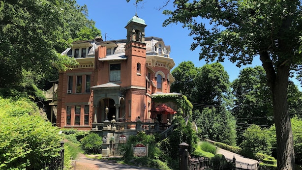 A large, historic building with a prominent tower and a covered porch. - The Harry Packer Mansion Inn (Jim Thorpe)