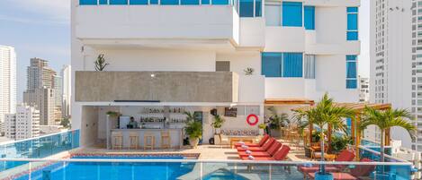 Outdoor pool, open 9:00 AM to 7:00 PM, pool umbrellas