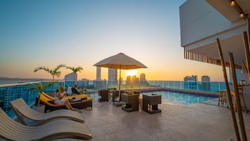 Outdoor pool, open 9:00 AM to 7:00 PM, pool umbrellas