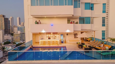 Outdoor pool, open 9:00 AM to 7:00 PM, pool umbrellas