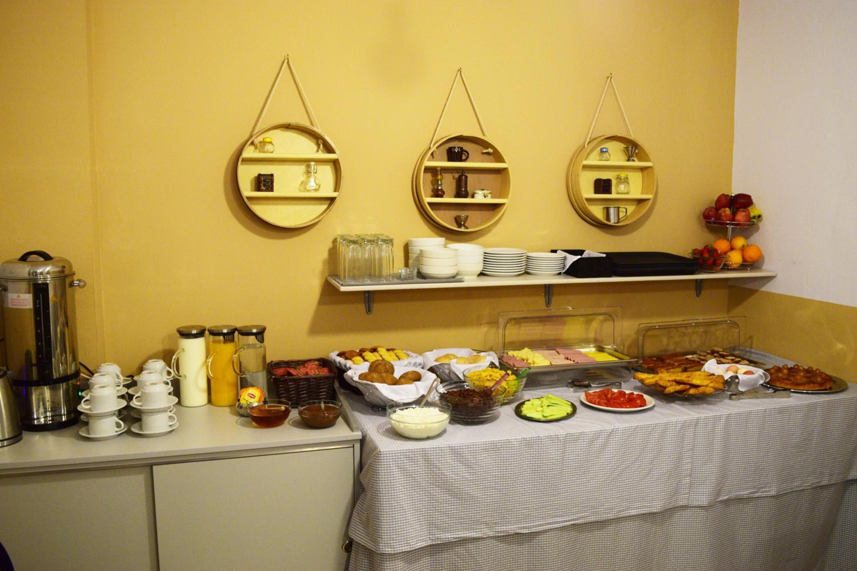 A buffet setup with various food items and condiments.