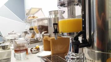 A coffee machine with a transparent milk frother, a coffee grinder, and a coffee press.