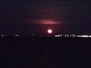 A night scene with a bright moon and distant city lights. - Bahceli Konak (Eceabat)