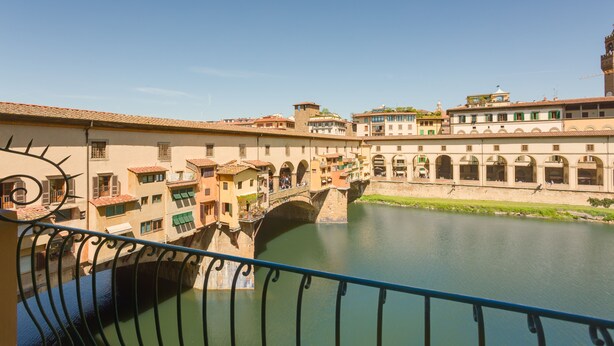 A historic bridge over a river with buildings on either side. - Ponte Vecchio Balcony (Florence)