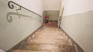 A staircase with a fire extinguisher mounted on the wall at the bottom. - San Marco Suite VII (Florence)
