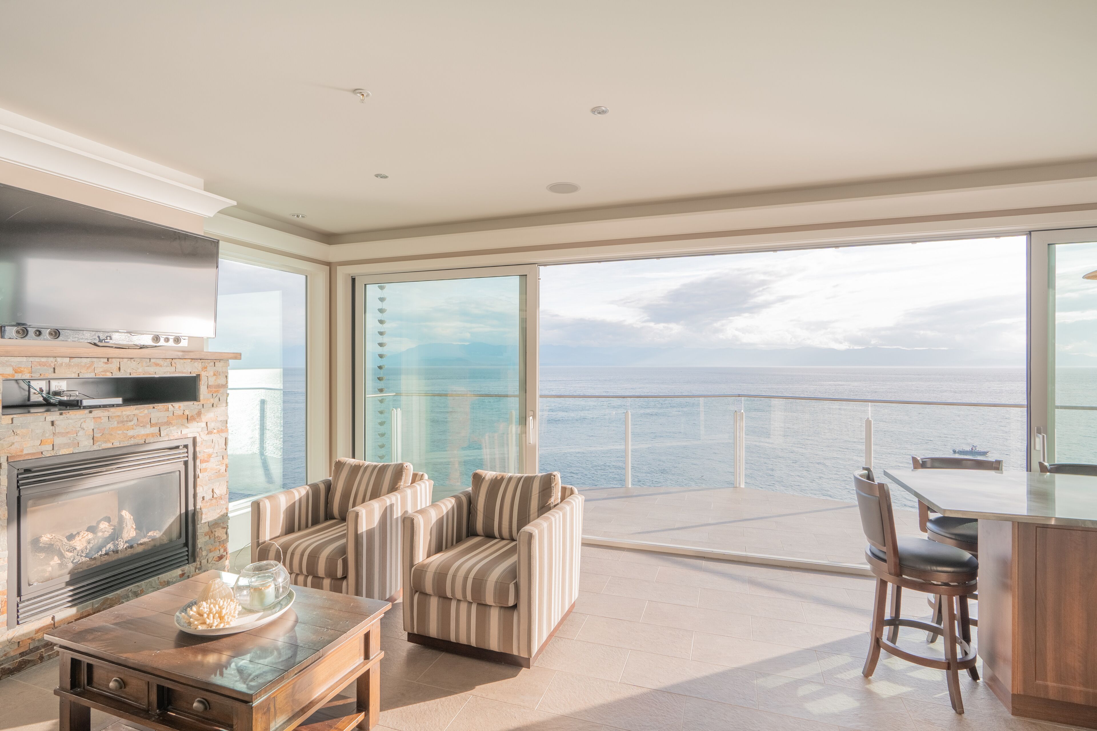 Signature Suite, 2 Bedrooms, Sea View | Living area | Flat-screen TV, fireplace