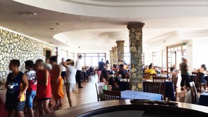 A spacious indoor dining area with stone pillars, multiple tables, and a high ceiling. - Suite Hotel Club Dominicus (Grisolia)