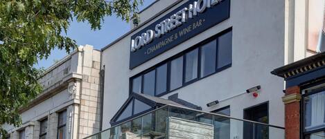 A hotel with a sign reading 'Lord Street Hotel' and 'Champagne & Wine Bar' below.