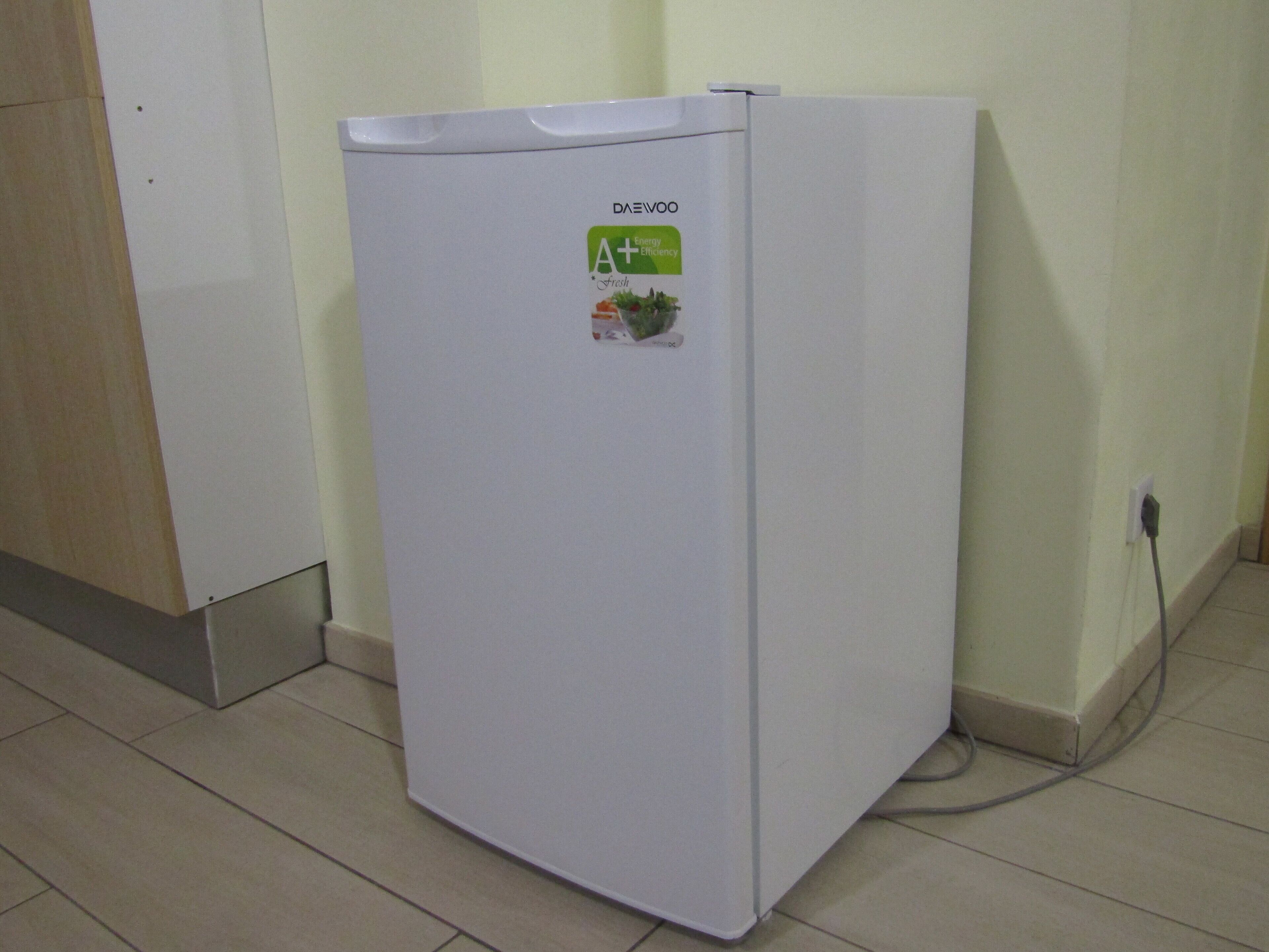 A white refrigerator with a sticker that reads "DAEVOO Fresh" and "A+ Energy".