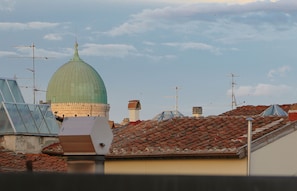A building with a green dome and multiple antennas on the roof. - Archino di San Piero (Florence)