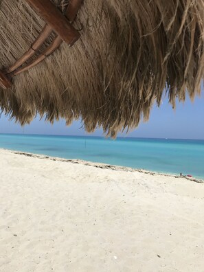 On the beach, sun-loungers, beach umbrellas, beach towels