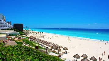 On the beach, white sand, free beach cabanas, sun loungers