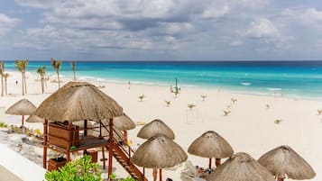 On the beach, white sand, free beach cabanas, sun loungers