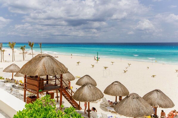 On the beach, white sand, free beach cabanas, sun loungers