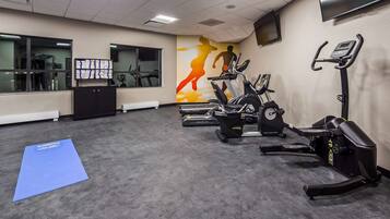 A gym with treadmills, an elliptical, and a stationary bike.