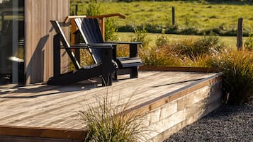 A modern building with a wooden exterior and a deck area.