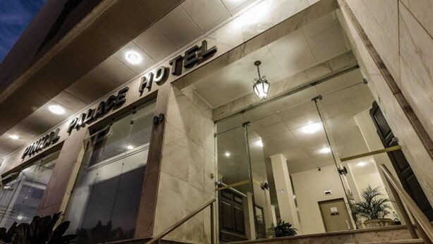 The exterior of the Planet Hotel with a modern facade, large glass windows, and a staircase leading to the entrance. - Pinhal Palace Hotel (Espirito Santo Do Pinhal)