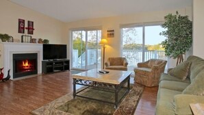 A living room with a fireplace, a television, a sofa, and a coffee table. - 5 o'clock Somewhere - Pool Table, Walking Distance to Portside Bar & Grill, Just Like New! (Moneta)