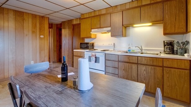 A compact kitchen with wooden cabinets, a microwave, a stove, and a sink. - Philip Arthur Suite, Apt #6
Hershey Penthouse overlooking all of Hershey (Hershey)