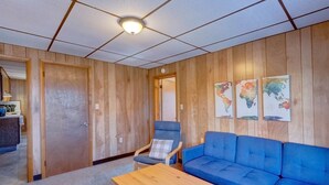 A room with wooden panel walls, a blue sofa, a wooden table, and a chair with a pillow. There are three world maps on the wall. - Philip Arthur Suite, Apt #6
Hershey Penthouse overlooking all of Hershey (Hershey)