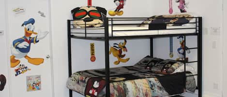 A bunk bed with Disney-themed decorations, including Mickey Mouse and Donald Duck.