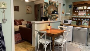 A compact living space with a dining area, kitchen, and a cozy seating area. - 2 Bedroom & 2 Bathroom Gîte Cottage Heated Plunge Pool & Private Garden 86150 (Le Vigeant)